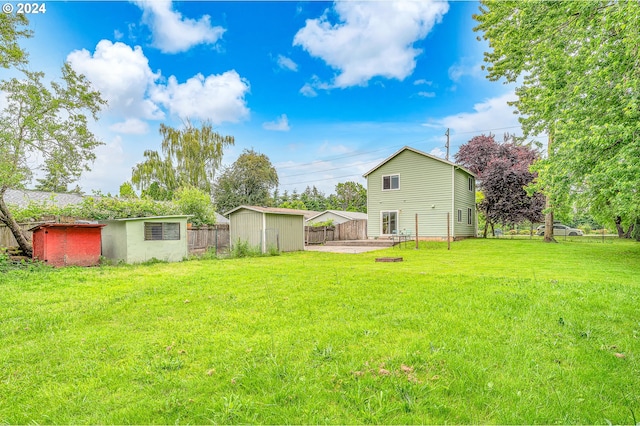 view of yard with a storage unit and a patio