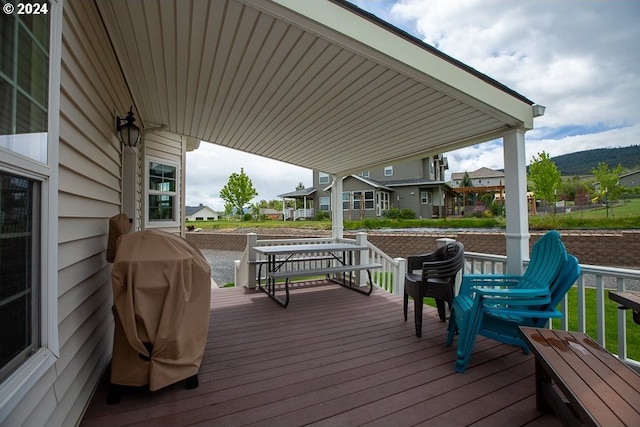 wooden terrace with a grill