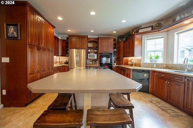 kitchen with dishwasher, sink, stainless steel fridge, a kitchen bar, and white microwave