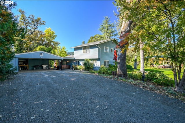 view of front facade with driveway and a carport