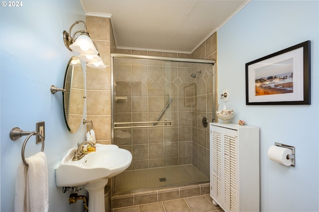 full bathroom with ornamental molding and a shower stall