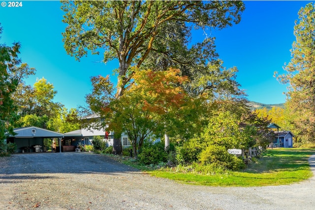 view of front of home featuring a carport and driveway