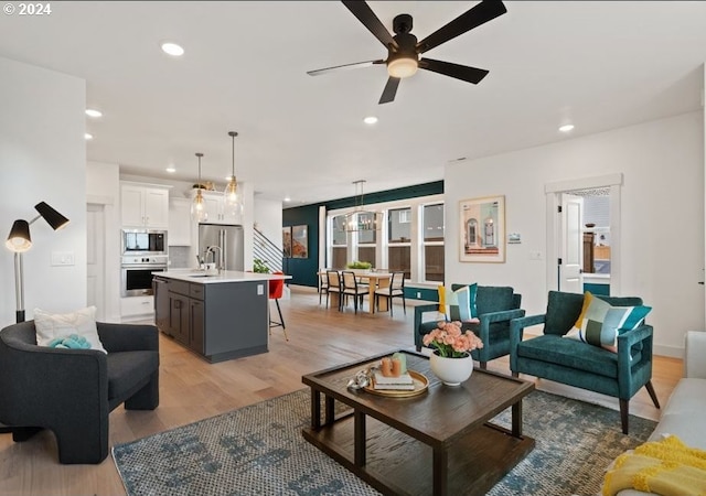 living room with hardwood / wood-style flooring and ceiling fan