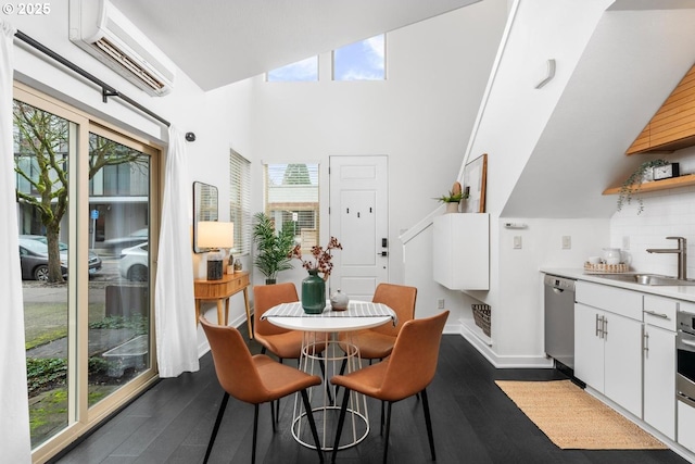 dining room with an AC wall unit, a healthy amount of sunlight, and sink