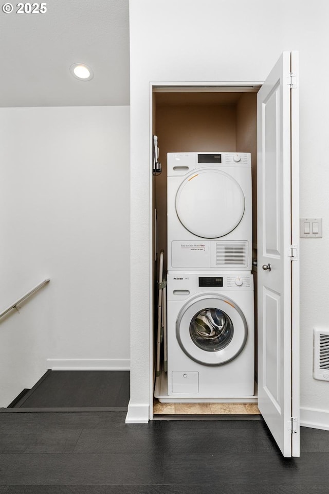 clothes washing area with stacked washer and clothes dryer