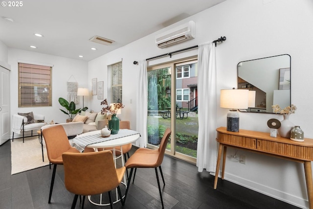 dining space featuring a healthy amount of sunlight and a wall unit AC