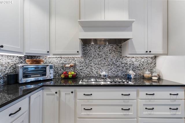 kitchen with backsplash, white cabinetry, and stainless steel gas stovetop