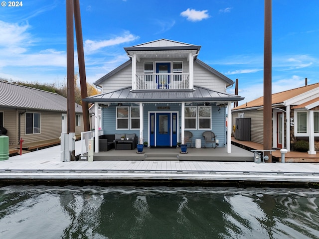 back of house featuring outdoor lounge area and a balcony