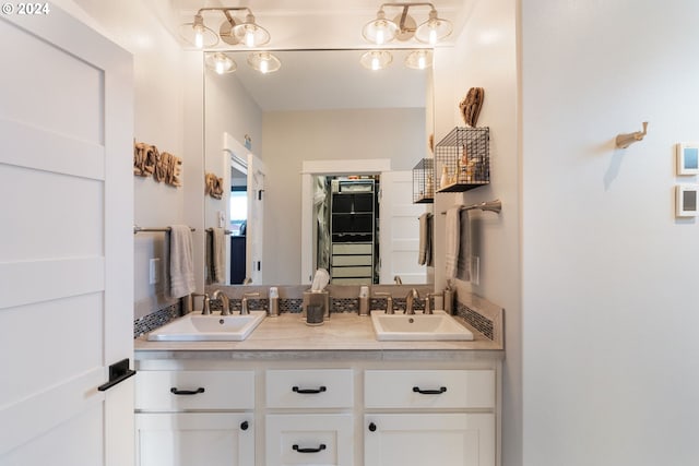 bathroom with vanity and a notable chandelier