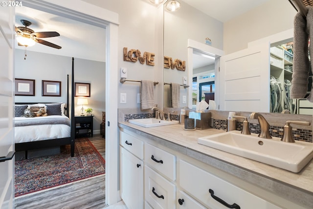 bathroom featuring ceiling fan, hardwood / wood-style floors, and vanity