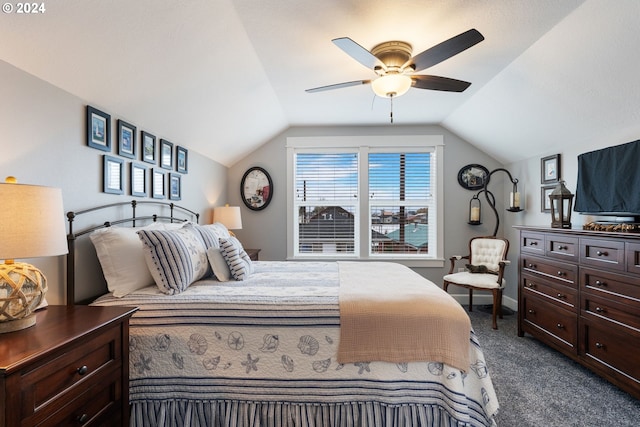 bedroom with ceiling fan, dark carpet, and lofted ceiling