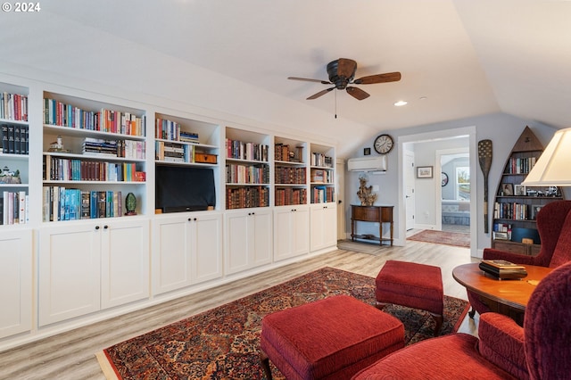 living room with a wall mounted AC, ceiling fan, light hardwood / wood-style flooring, and lofted ceiling