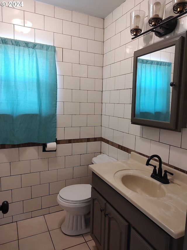 bathroom featuring vanity, tile patterned floors, decorative backsplash, toilet, and tile walls