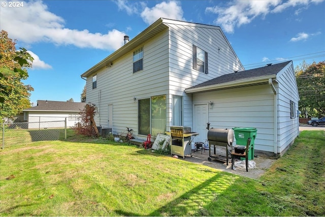 back of house featuring a yard and a patio area