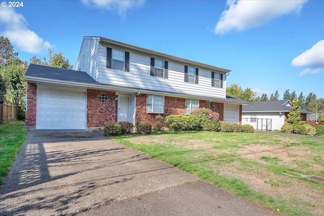 view of front of property featuring a front lawn and a garage