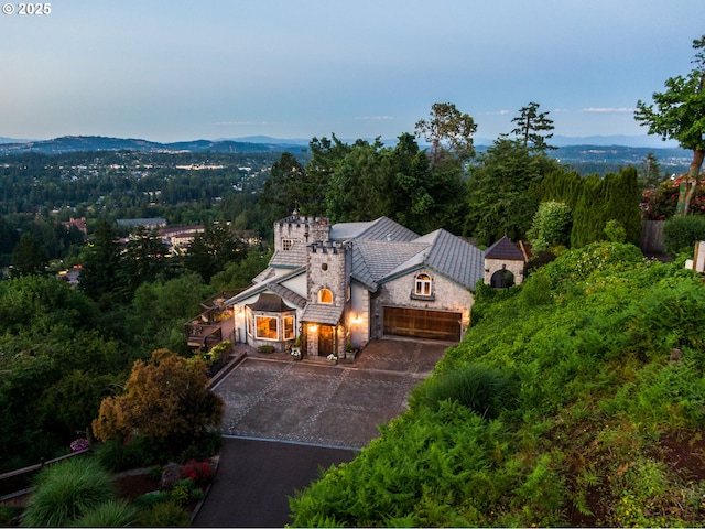 aerial view featuring a mountain view and a view of trees