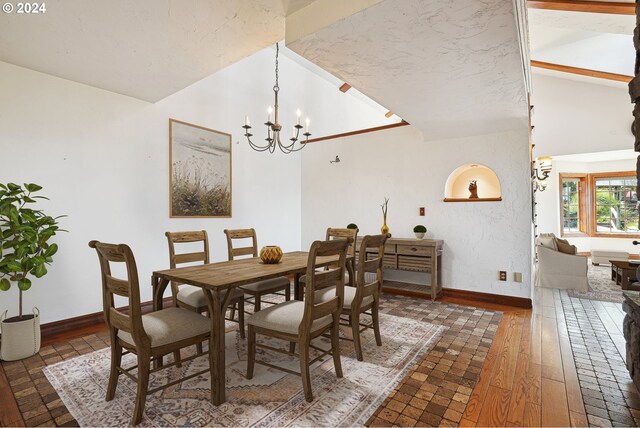 unfurnished living room with an inviting chandelier, wood finished floors, and a towering ceiling