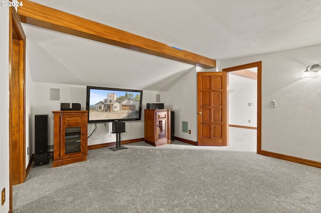 interior space with vaulted ceiling with beams and baseboards