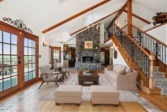 living room featuring beam ceiling, french doors, an inviting chandelier, light hardwood / wood-style flooring, and high vaulted ceiling