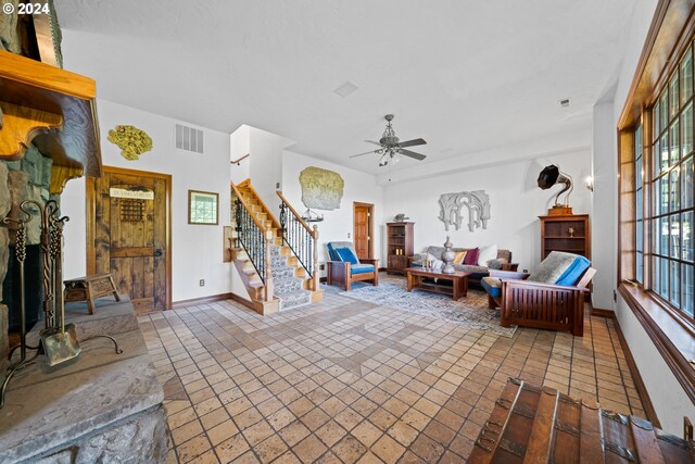 wine area with vaulted ceiling, baseboards, stone tile flooring, and a textured ceiling