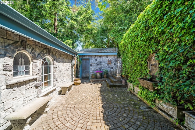 view of patio with an outbuilding