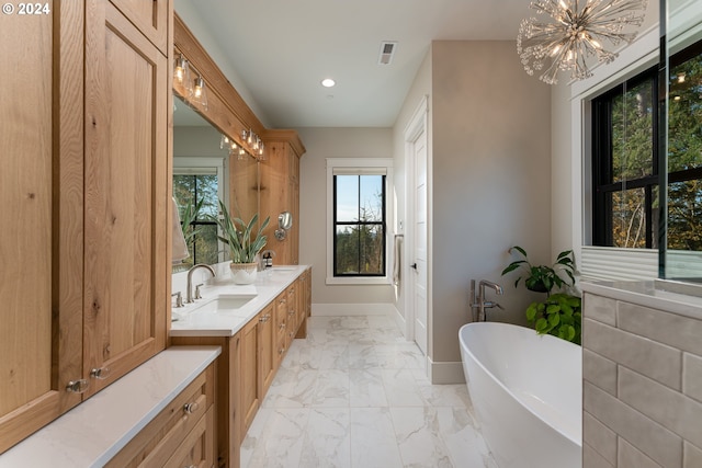 bathroom with a bathing tub, vanity, and a chandelier