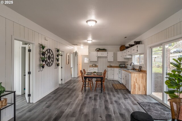 kitchen featuring white cabinetry, dark hardwood / wood-style floors, and white appliances