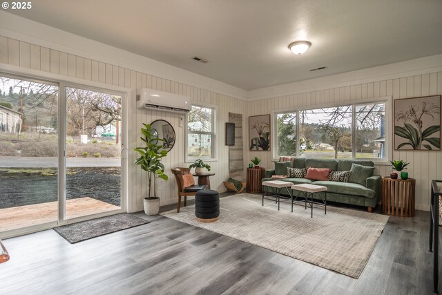 unfurnished living room with light hardwood / wood-style flooring, wooden walls, and sink