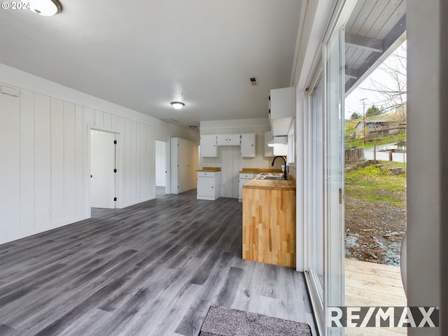 kitchen with white cabinetry, sink, wooden counters, and dark hardwood / wood-style floors