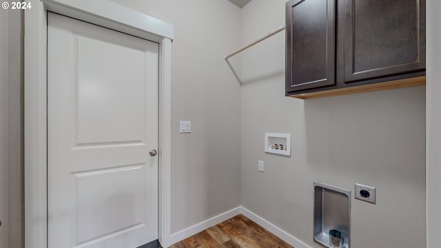 clothes washing area with cabinets, washer hookup, dark hardwood / wood-style floors, and electric dryer hookup