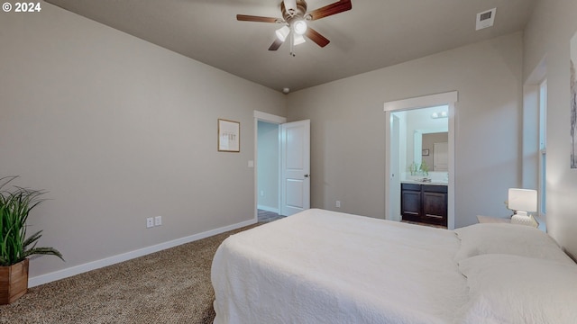 carpeted bedroom with ceiling fan and ensuite bath