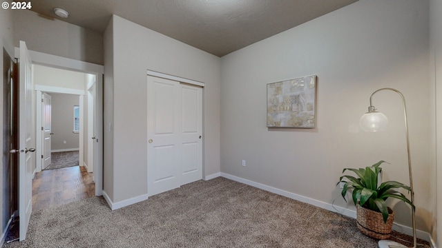 unfurnished bedroom with carpet and a textured ceiling