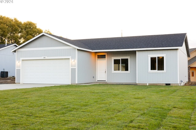 single story home featuring a garage, central air condition unit, and a front lawn