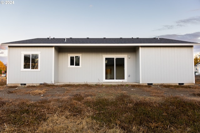 view of back house at dusk