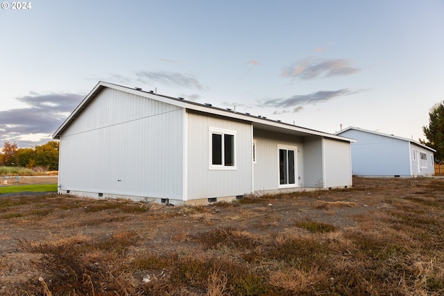 view of back house at dusk