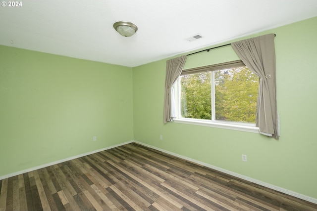 spare room featuring dark wood-type flooring