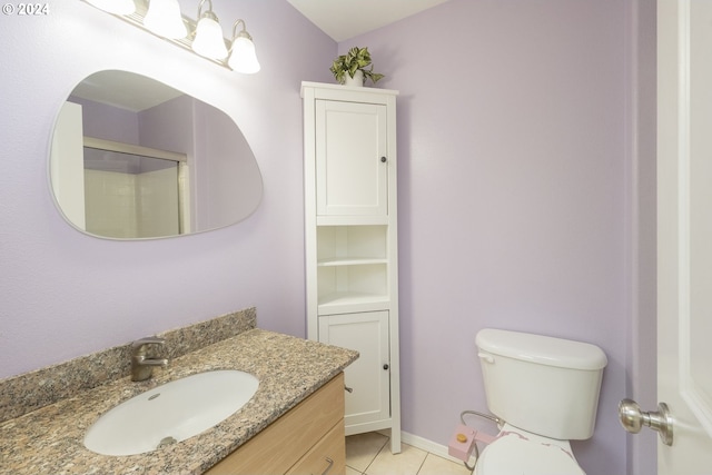 bathroom featuring tile patterned floors, toilet, a shower with door, and vanity