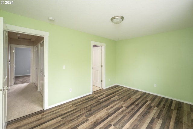 unfurnished bedroom with dark hardwood / wood-style flooring