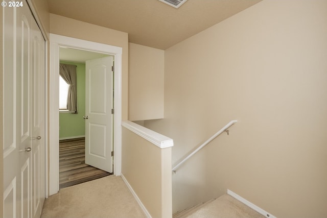 corridor with light hardwood / wood-style floors