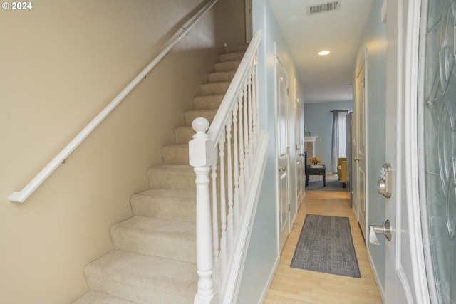 staircase featuring hardwood / wood-style flooring