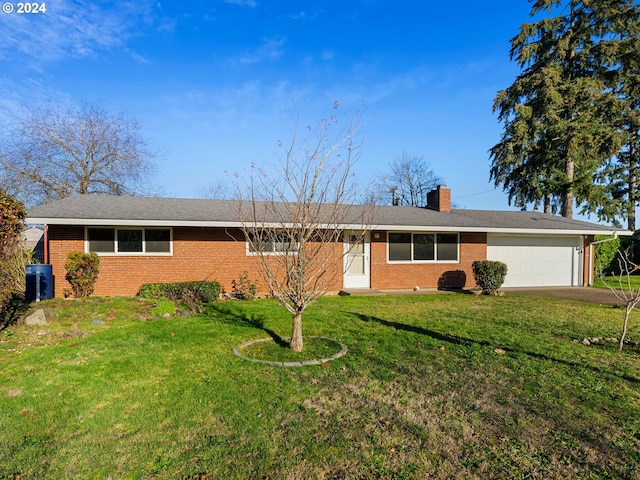 single story home featuring a garage and a front lawn