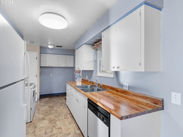 kitchen featuring white cabinets, white appliances, and sink