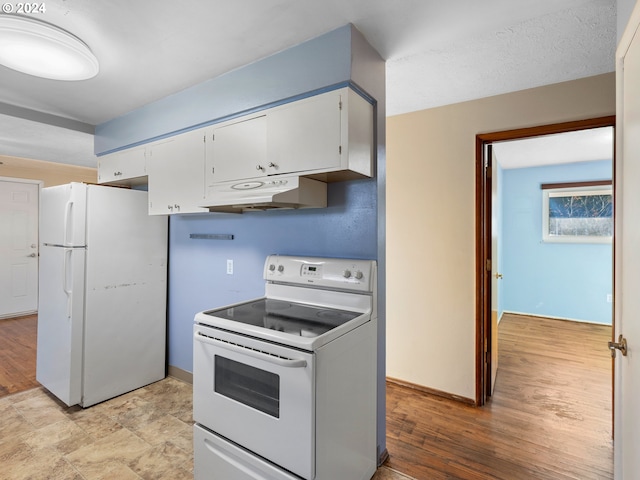 kitchen featuring a textured ceiling, light hardwood / wood-style flooring, white cabinets, and white appliances