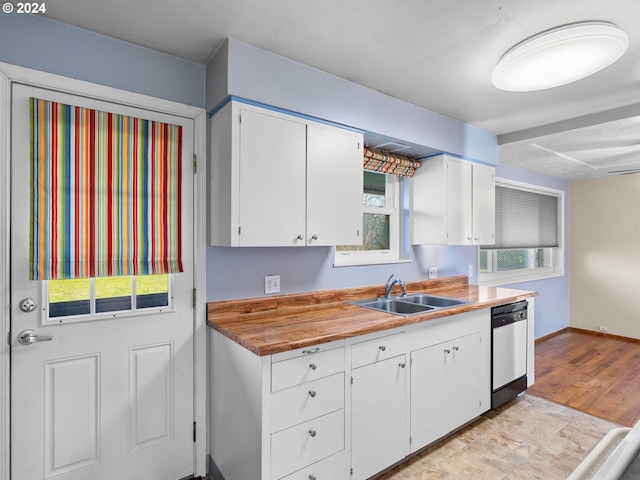 kitchen featuring white cabinets, light wood-type flooring, dishwasher, and sink