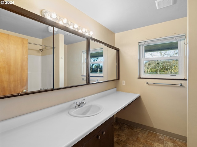 bathroom featuring vanity and walk in shower