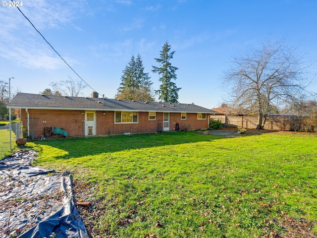 back of property featuring a lawn