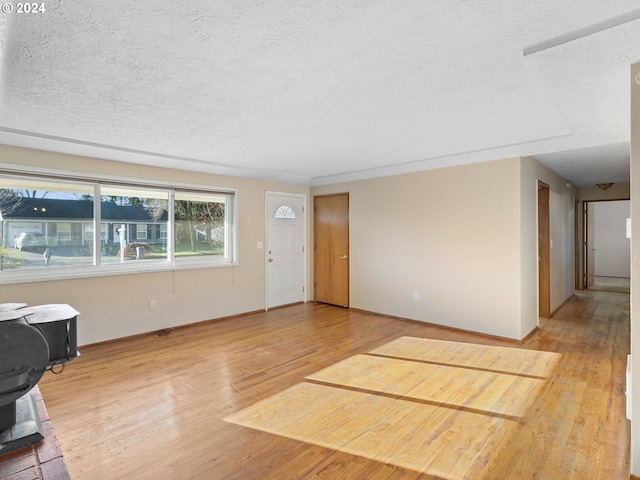 interior space featuring a textured ceiling and hardwood / wood-style flooring