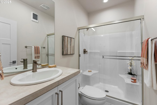 bathroom featuring an enclosed shower, vanity, and toilet