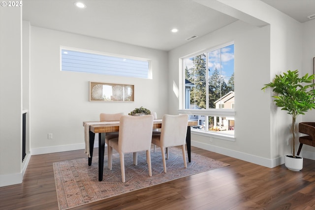 kitchen with a kitchen bar, hanging light fixtures, a center island with sink, appliances with stainless steel finishes, and white cabinets