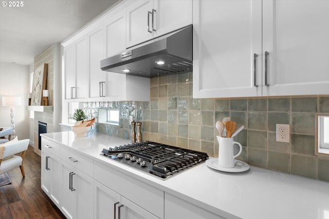 kitchen featuring wine cooler, stainless steel gas cooktop, dark hardwood / wood-style floors, decorative backsplash, and white cabinets